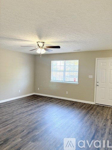 A room with a window and a door is available for rent.