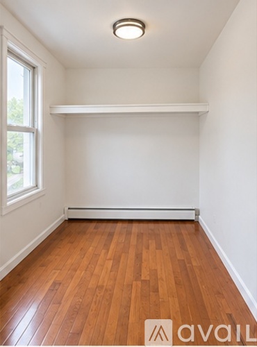 A room with wooden floors and a window.