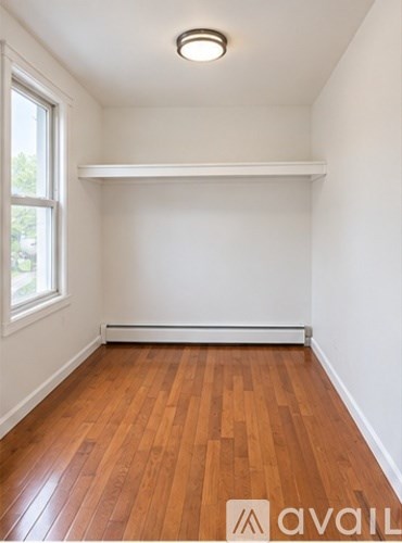 A room with wooden floors and a window.