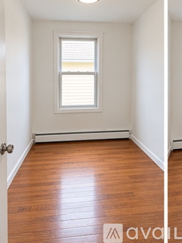 A room with wooden floors and a window.