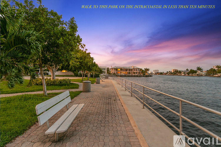 A walkway along the Intracoastal with a bench on the left side.