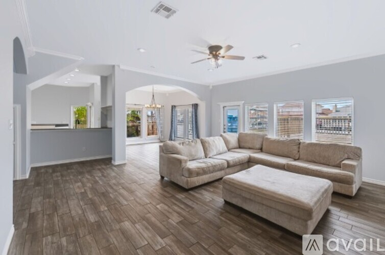 A spacious living room with a large sectional sofa and a coffee table.
