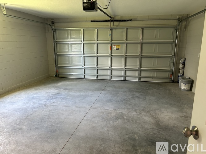 A spacious garage with a closed metal door.