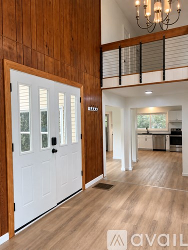A white door with a black handle is on the left side of the image.