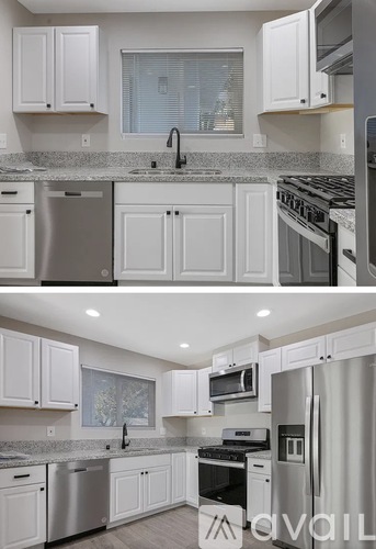 A kitchen with white cabinets and stainless steel appliances.