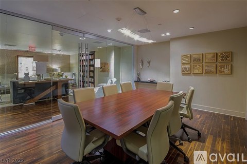 A conference room with a long table and chairs.