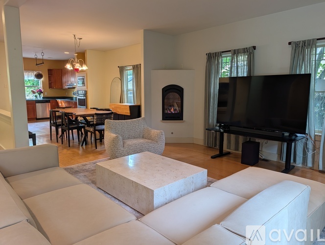 A living room with a fireplace and a television.