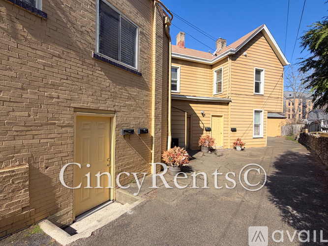 A yellow door is on the left side of a building.