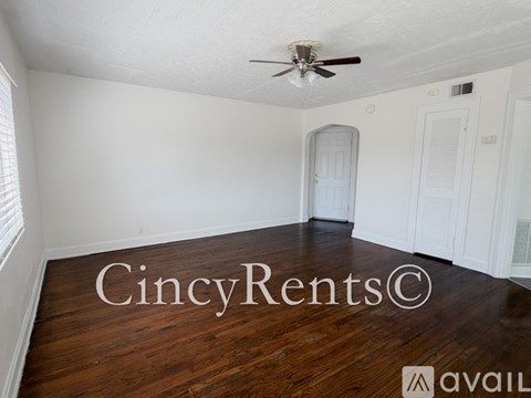 A room with a wooden floor and a ceiling fan.