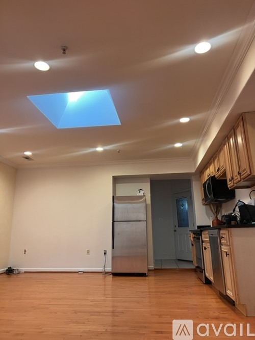 A kitchen with a refrigerator and cabinets.