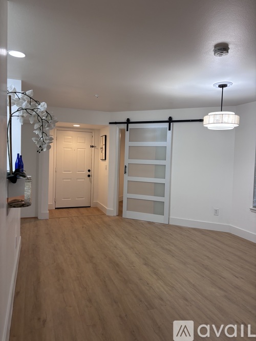 A room with wooden floors and a white ceiling with a light fixture.