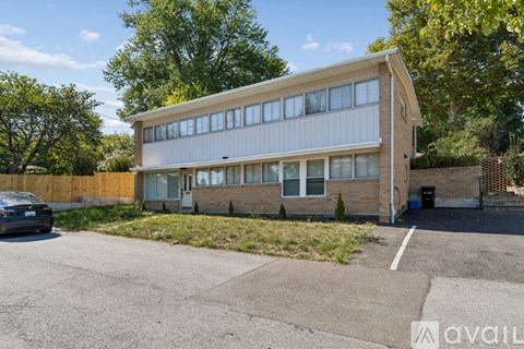 A two-story building with a parking lot in front.