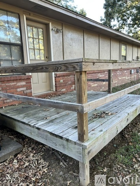 A wooden deck in front of a house.