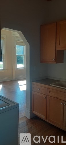 A kitchen with wooden cabinets and a dishwasher.