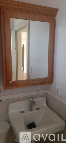 A bathroom with a sink, mirror and toilet.