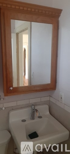 A bathroom with a sink, mirror and toilet.