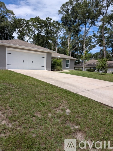 A house with a white garage door is for sale.