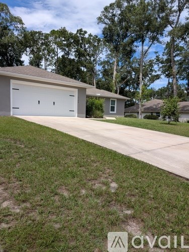 A house with a white garage door is for sale.