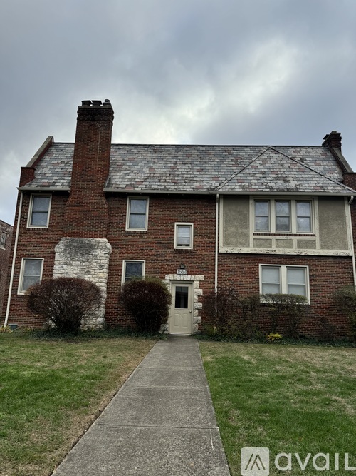 A brick house with a white door and windows.