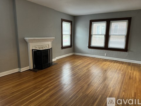 A room with a fireplace and wooden floors.
