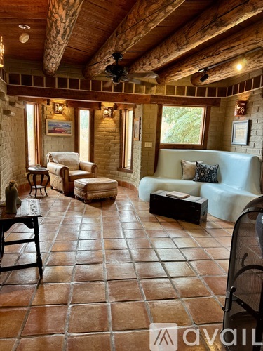 A living room with a couch, chair, and table.