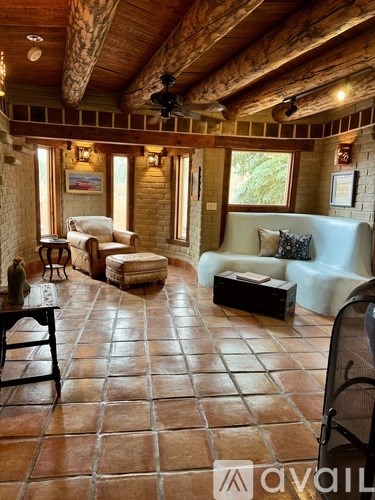 A living room with a couch, chair, and table.