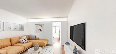 A living room with a couch, coffee table, and a flat screen TV mounted on the wall.
