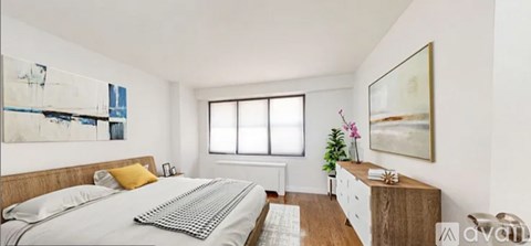 A bedroom with a large bed and a painting on the wall.