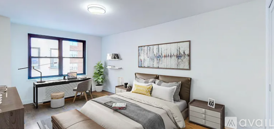 A bedroom with a large bed and a painting on the wall.