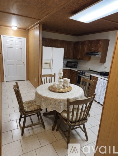 A kitchen with a table set for two.