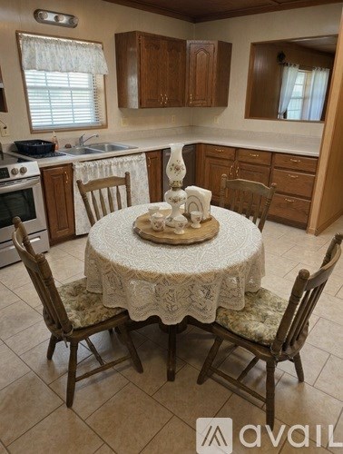 A kitchen with a table set for four.