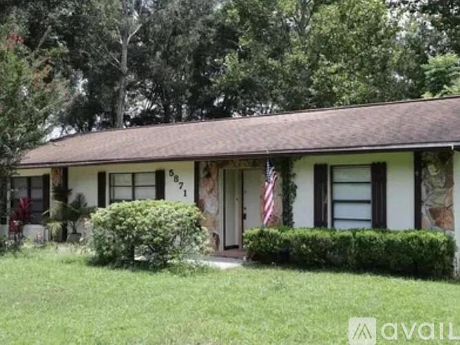 A house with a flag on the front porch.