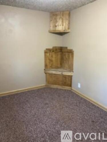 A room with a wooden chest in the corner.