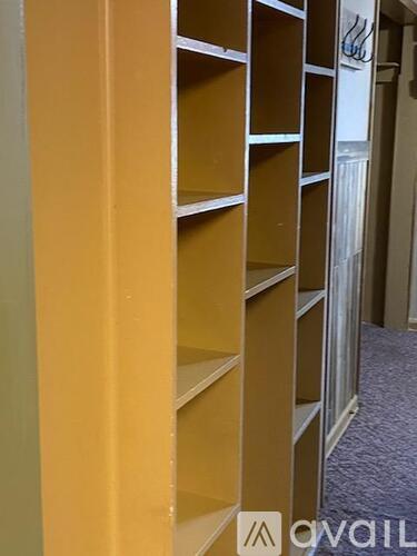 A row of empty shelves in a room.
