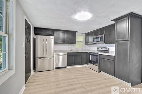 A kitchen with wooden cabinets and stainless steel appliances.