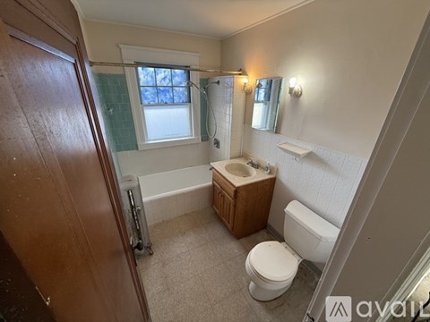 A bathroom with a toilet, sink, and bathtub.