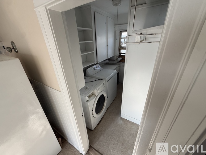 A small laundry room with a washer and dryer.