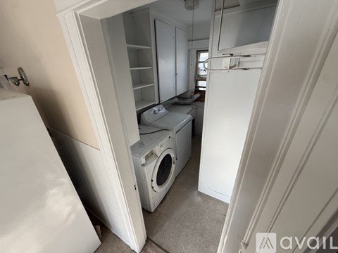 A small laundry room with a washer and dryer.