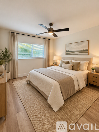 A bedroom with a large bed and a ceiling fan.