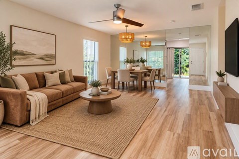 A living room with a brown sofa and a coffee table.