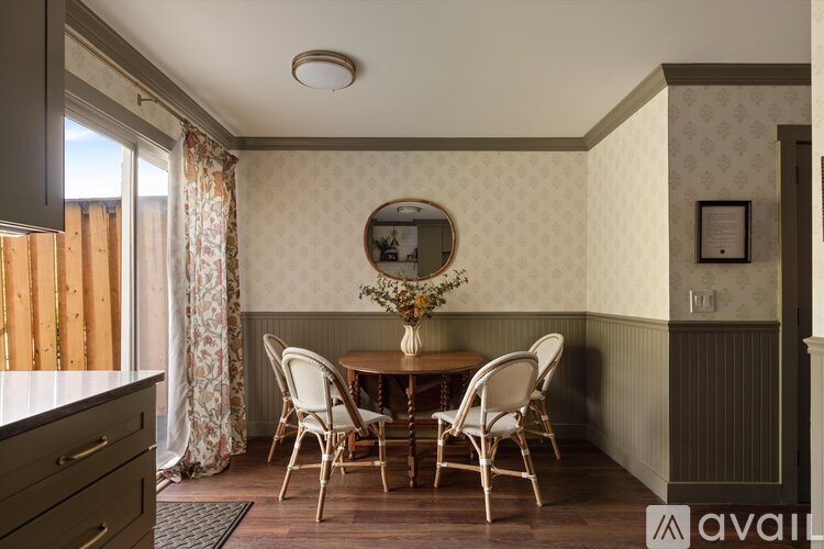 A dining room with a table set for four.