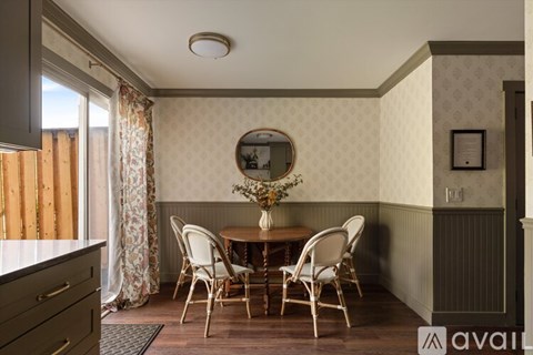 A dining room with a table set for four.
