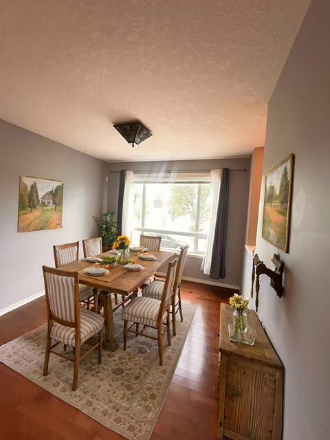 A dining room with a table set for six.