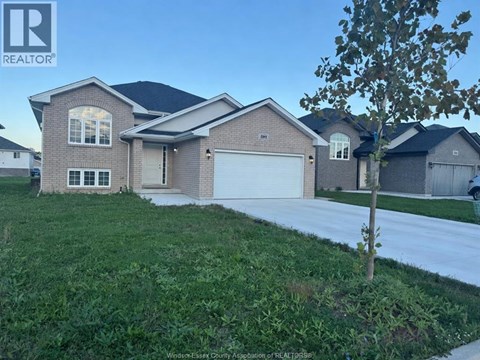 A house with a REALTOR® sign in front of it.