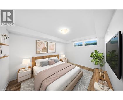 A bedroom with a large bed and a flat screen TV mounted on the wall.