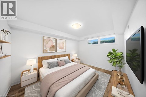 A bedroom with a large bed and a flat screen TV mounted on the wall.