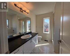 A bathroom with two sinks and a toilet.