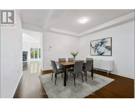 A dining room with a table set for four.