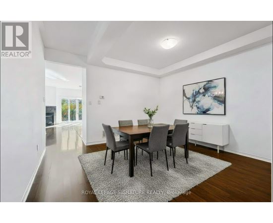A dining room with a table set for four.