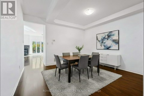 A dining room with a table set for four.